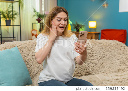 Pregnant woman exclaims wow at huge baby clothes sale discount seen on smartphone amazed by savings Pregnant woman exclaims wow at huge baby clothes sale discount seen on smartphone amazed by savings 139835492