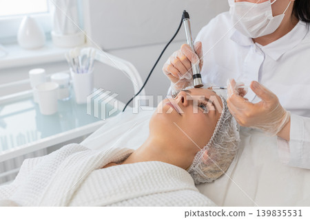 Electroporation non-injection face therapy for woman by beautician in aesthetic cosmetology clinic Electroporation non-injection face therapy for woman by beautician in aesthetic cosmetology clinic 139835531