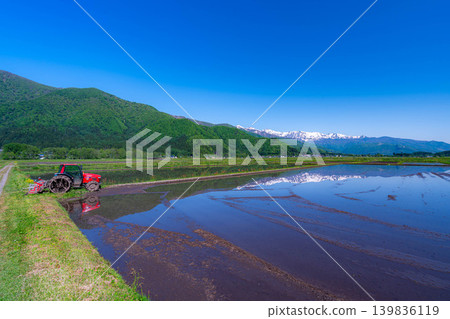 [Early Summer Scenery] Fresh Greenery in Hakuba Village - Tractors and Rural Landscapes [Nagano Prefecture] 139836119