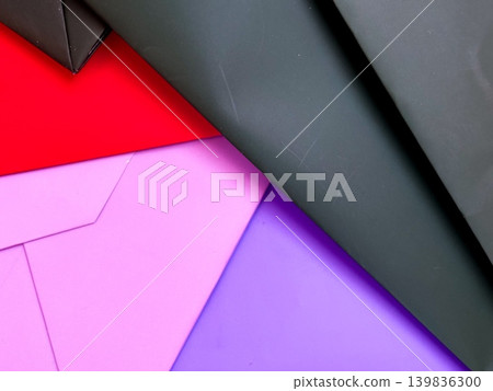 Different sheets of paper on flat surface, red, pink, purple and black colors. Decorative background for design. Various angles, creating layered effect. Textures and colors of paper Different sheets of paper on flat surface, red, pink, purple and black colors. Decorative background for design. Various angles, creating layered effect. Textures and colors of paper 139836300