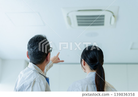 Workers inspecting air conditioners Workers inspecting air conditioners 139836358