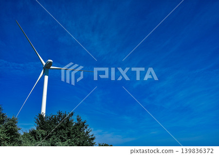 Wind turbines spinning widely in the blue sky Wind turbines spinning widely in the blue sky 139836372