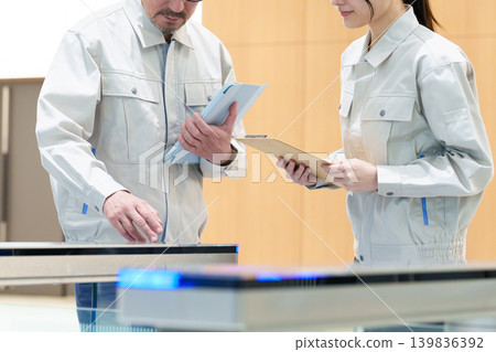 Workers inspecting security gates 139836392