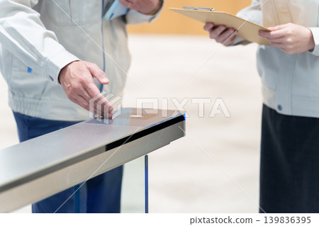 Workers inspecting security gates 139836395