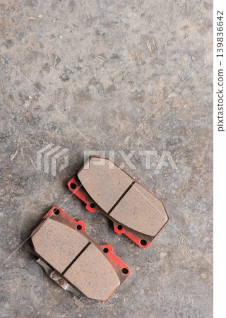 New automotive brake pads on concrete floor ready for maintenance repair replacement vehicle service in garage workshop New automotive brake pads on concrete floor ready for maintenance repair replacement vehicle service in garage workshop 139836642