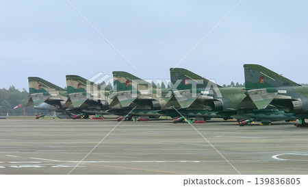 Japan Air Self-Defense Force RF-4E Phantom II reconnaissance aircraft lined up on the apron. Japan Air Self-Defense Force RF-4E Phantom II reconnaissance aircraft lined up on the apron. 139836805