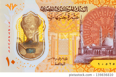 Detailed fragment of Egyptian pound currency fragment with Ten LE polymer banknote portrait of Ramses II beside pyramids. Detailed fragment of Egyptian pound currency fragment with Ten LE polymer banknote portrait of Ramses II beside pyramids. 139836810
