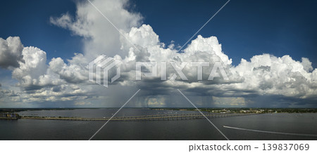 Heavy thunderstorm approaching traffic bridge connecting Punta Gorda and Port Charlotte over Peace River. Bad weather conditions for driving during rainy season in Florida Heavy thunderstorm approaching traffic bridge connecting Punta Gorda and Port Charlotte over Peace River. Bad weather conditions for driving during rainy season in Florida 139837069