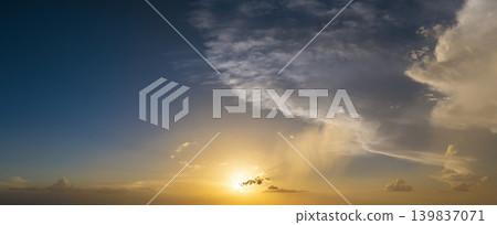 Beautiful sunset sky scenery. Bright colorful orange and yellow clouds on horizon Beautiful sunset sky scenery. Bright colorful orange and yellow clouds on horizon 139837071