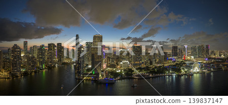 Night urban landscape of downtown district of Miami Brickell in Florida, USA. Skyline with brightly illuminated high skyscraper buildings in modern american megapolis Night urban landscape of downtown district of Miami Brickell in Florida, USA. Skyline with brightly illuminated high skyscraper buildings in modern american megapolis 139837147