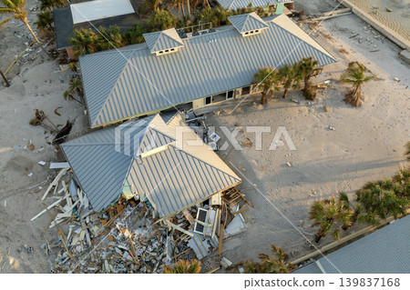 Storm surge severe damage to residential houses on ocean shore after hurricane landfall. Natural disaster consequences in Florida Storm surge severe damage to residential houses on ocean shore after hurricane landfall. Natural disaster consequences in Florida 139837168