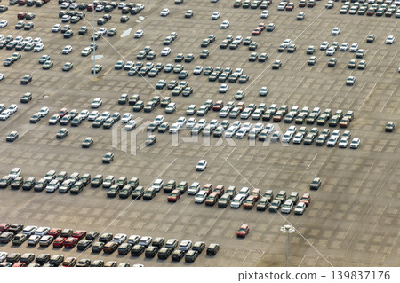 Automotive industry. Import or export of new cars at production factory warehouse. Vehicles for sale at logistics business parking lot 139837176