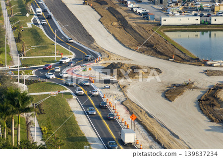 Roundabout construction roadworks on American transport infrastructure. Renovation of highway road with moving traffic. Development of interstate transportation concept Roundabout construction roadworks on American transport infrastructure. Renovation of highway road with moving traffic. Development of interstate transportation concept 139837234