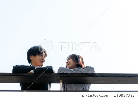 A couple talking on the rooftop A couple talking on the rooftop 139837382