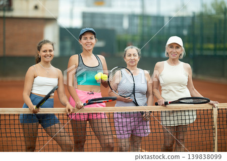 Group of women posing on tennis court Group of women posing on tennis court 139838099
