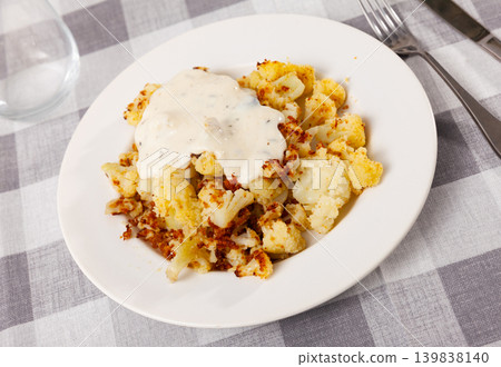 Fried cauliflower served with sauce on platter Fried cauliflower served with sauce on platter 139838140