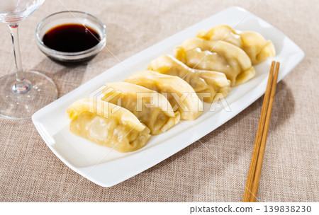 Steamed dumplings gyoza with meat filling served with sauce Steamed dumplings gyoza with meat filling served with sauce 139838230