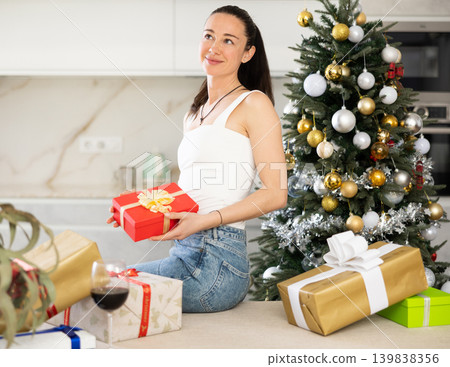 .in homely atmosphere, girl is waiting for new year .in homely atmosphere, girl is waiting for new year 139838356