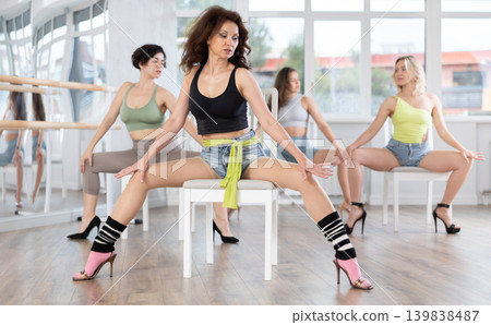 Group of women doing high heels dance class Group of women doing high heels dance class 139838487