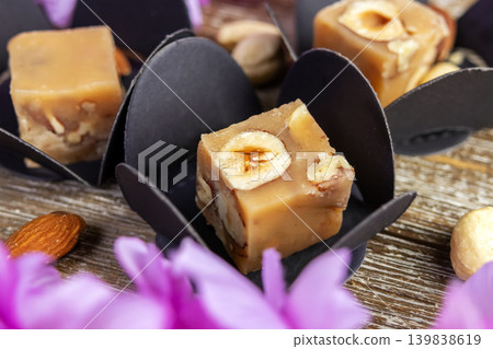 Butter caramel fudge squares with hazelnuts and wisteria. Butter caramel fudge squares with hazelnuts and wisteria. 139838619