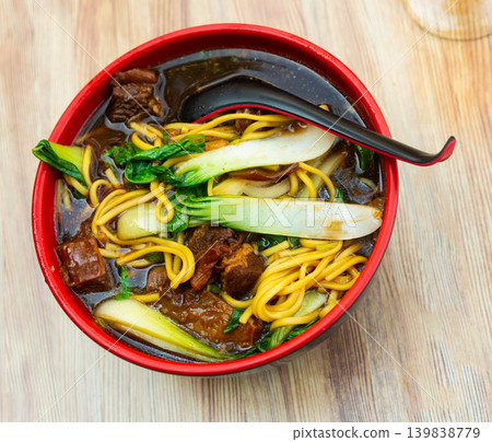 Ramen soup with wheat noodles, beef and swiss chard 139838779