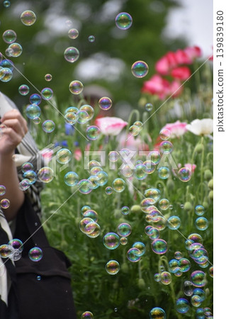 Soap bubbles floating in a flower field 139839180