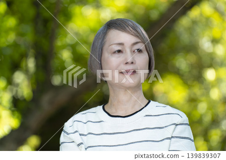 Senior women watching sports on a park bench surrounded by fresh greenery. Senior women watching sports on a park bench surrounded by fresh greenery. 139839307