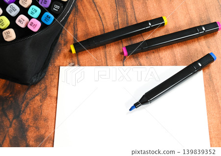 close up of art markers on white sheet of paper on table close up of art markers on white sheet of paper on table 139839352