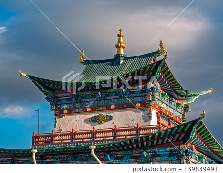 Vibrant Ivolginsky Datsan temple building details display green tiered roofs, golden spire, and intricate facade decorations Vibrant Ivolginsky Datsan temple building details display green tiered roofs, golden spire, and intricate facade decorations 139839491