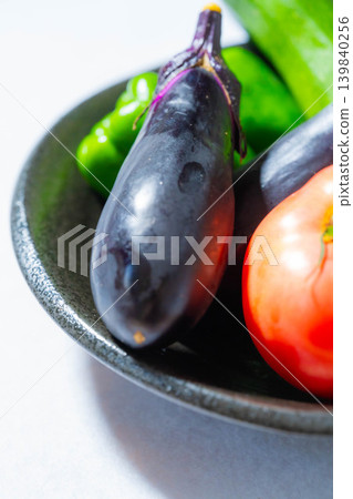 Assortment of fresh, dewy summer vegetables: tomatoes, eggplant, cucumbers, zucchini, and peppers Assortment of fresh, dewy summer vegetables: tomatoes, eggplant, cucumbers, zucchini, and peppers 139840256