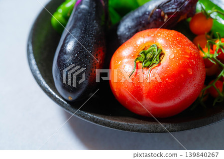 Assortment of fresh, dewy summer vegetables: tomatoes, eggplant, cucumbers, zucchini, and peppers 139840267