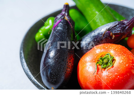 Assortment of fresh, dewy summer vegetables: tomatoes, eggplant, cucumbers, zucchini, and peppers Assortment of fresh, dewy summer vegetables: tomatoes, eggplant, cucumbers, zucchini, and peppers 139840268