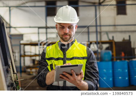 Hard hat and high-visibility vest cover the worker's gear Hard hat and high-visibility vest cover the worker's gear 139840573
