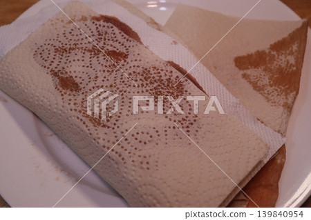 Stained Paper-Wrapped Food on White Plate Stained Paper-Wrapped Food on White Plate 139840954