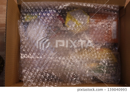 Bubble-wrapped items in cardboard box Bubble-wrapped items in cardboard box 139840993