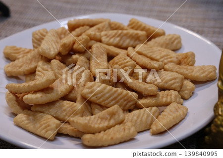 Plate of Ridged Golden Brown Crackers Close-Up Plate of Ridged Golden Brown Crackers Close-Up 139840995