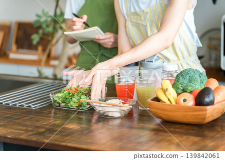 The hands of a female instructor and a female student teaching cooking at a cooking class/school. The hands of a female instructor and a female student teaching cooking at a cooking class/school. 139842061