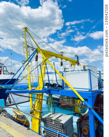 Boat platform in a harbor with blue sky and fluffy clouds during midday Boat platform in a harbor with blue sky and fluffy clouds during midday 139842508