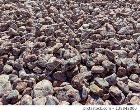 Rocks spread across the ground in a dry area during the daytime Rocks spread across the ground in a dry area during the daytime 139842800