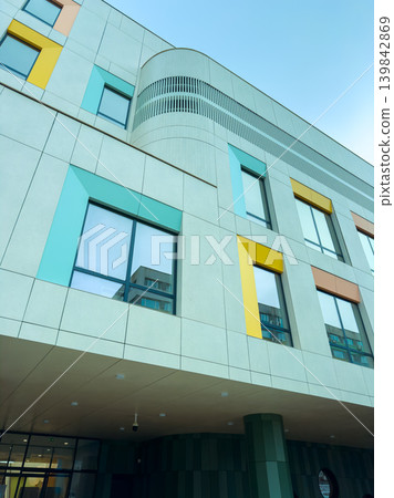 Building with colorful window accents in a modern urban setting during daylight hours Building with colorful window accents in a modern urban setting during daylight hours 139842869