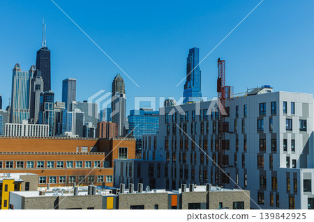 City skyline view showing tall buildings and clear blue sky on a sunny day in Chicago, highlighting architectural design and urban landscape in the afternoon City skyline view showing tall buildings and clear blue sky on a sunny day in Chicago, highlighting architectural design and urban landscape in the afternoon 139842925