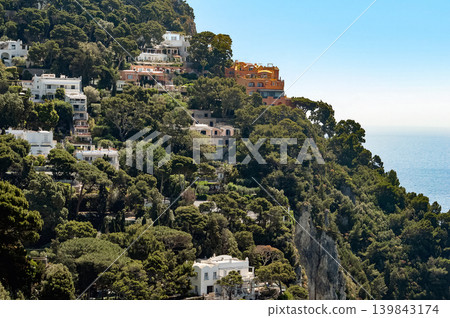 Coastal slopes of the island Capri with luxurious villas located on them. 139843174