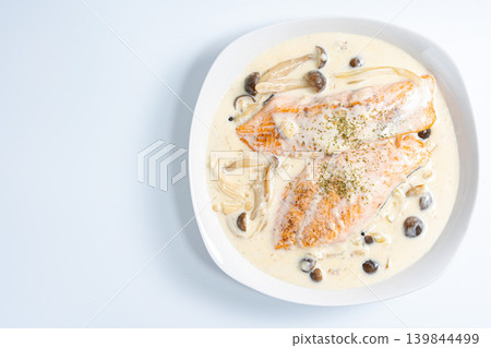 Creamy salmon and mushrooms placed against a white background. Creamy salmon and mushrooms placed against a white background. 139844499