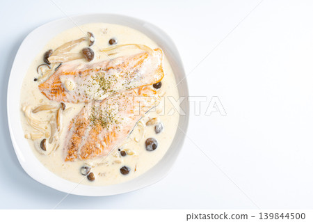 Creamy salmon and mushrooms placed against a white background. Creamy salmon and mushrooms placed against a white background. 139844500
