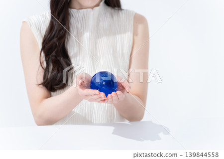 A woman with a globe hand A woman with a globe hand 139844558
