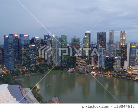 A view of Singapore's financial district and skyscrapers at sunset, seen from Marina Bay Sands. A view of Singapore's financial district and skyscrapers at sunset, seen from Marina Bay Sands. 139844613