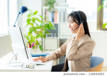 Female operator working in the office Female operator working in the office 139844801