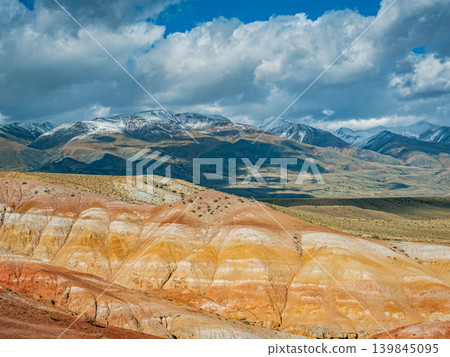 A panoramic view of the Altai region on Mars, featuring vibrant red and yellow stratified hills A panoramic view of the Altai region on Mars, featuring vibrant red and yellow stratified hills 139845095