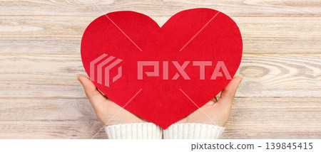 woman hand holding paper red heart shape. copy space woman hand holding paper red heart shape. copy space 139845415