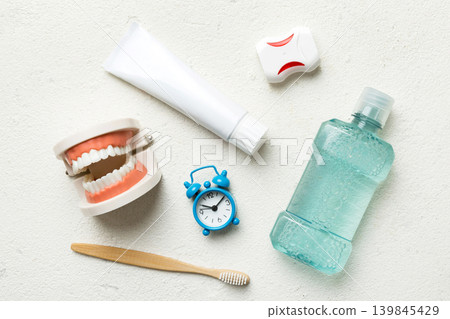 Mouthwash and other oral hygiene products on colored table top view with copy space. Flat lay. Dental hygiene. Oral care kit. Dentist concept Mouthwash and other oral hygiene products on colored table top view with copy space. Flat lay. Dental hygiene. Oral care kit. Dentist concept 139845429